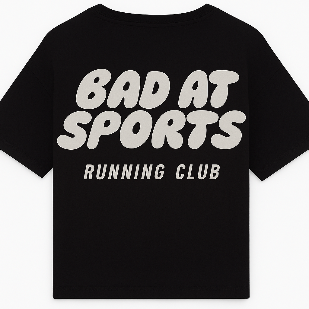 Black t-shirt with 'Bad at Sports Running Club' text on a white background