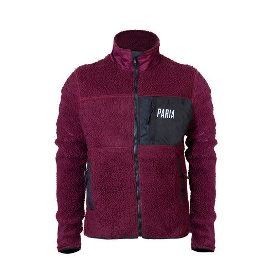 A purple fleece cycling jacket with zip pockets and contrast zips, featuring a collar and the brand name 'Paria' on the chest.