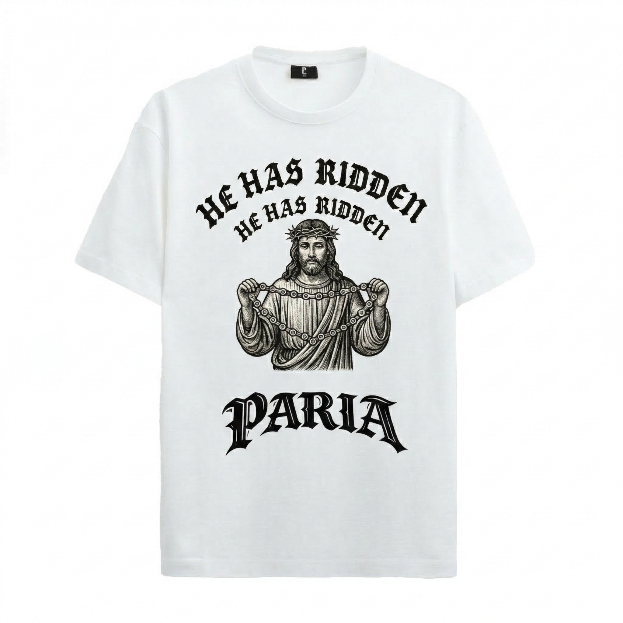 A white organic cotton t-shirt featuring a black woodcut-style graphic of Jesus Christ wearing a crown of thorns and holding a bicycle chain. Above the figure, the text reads "HE HAS RIDDEN" in a curved gothic font, with the PARIA brand logo in a matching black gothic typeface at the bottom.