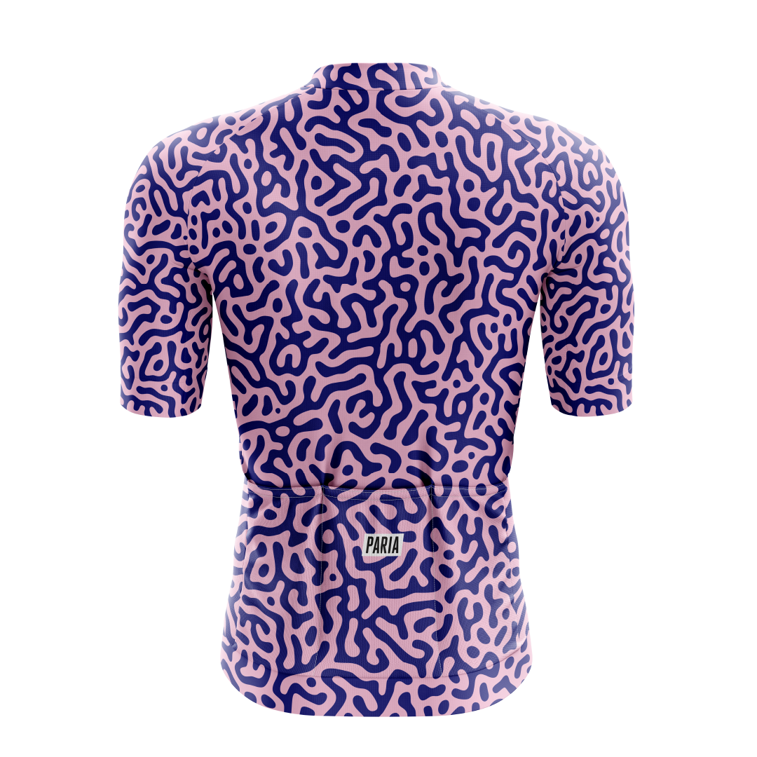 [design:Kinetic] Back view. A short sleeve cycling jersey featuring a geometric pattern in purple and blue colors.