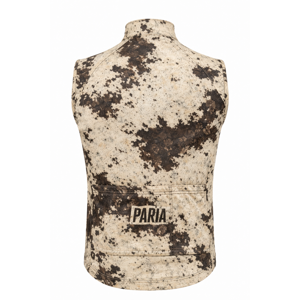 A PARIA cycling gilet in cow print featuring all over camo style print in black white and cream with 3 pockets and a PARIA logo