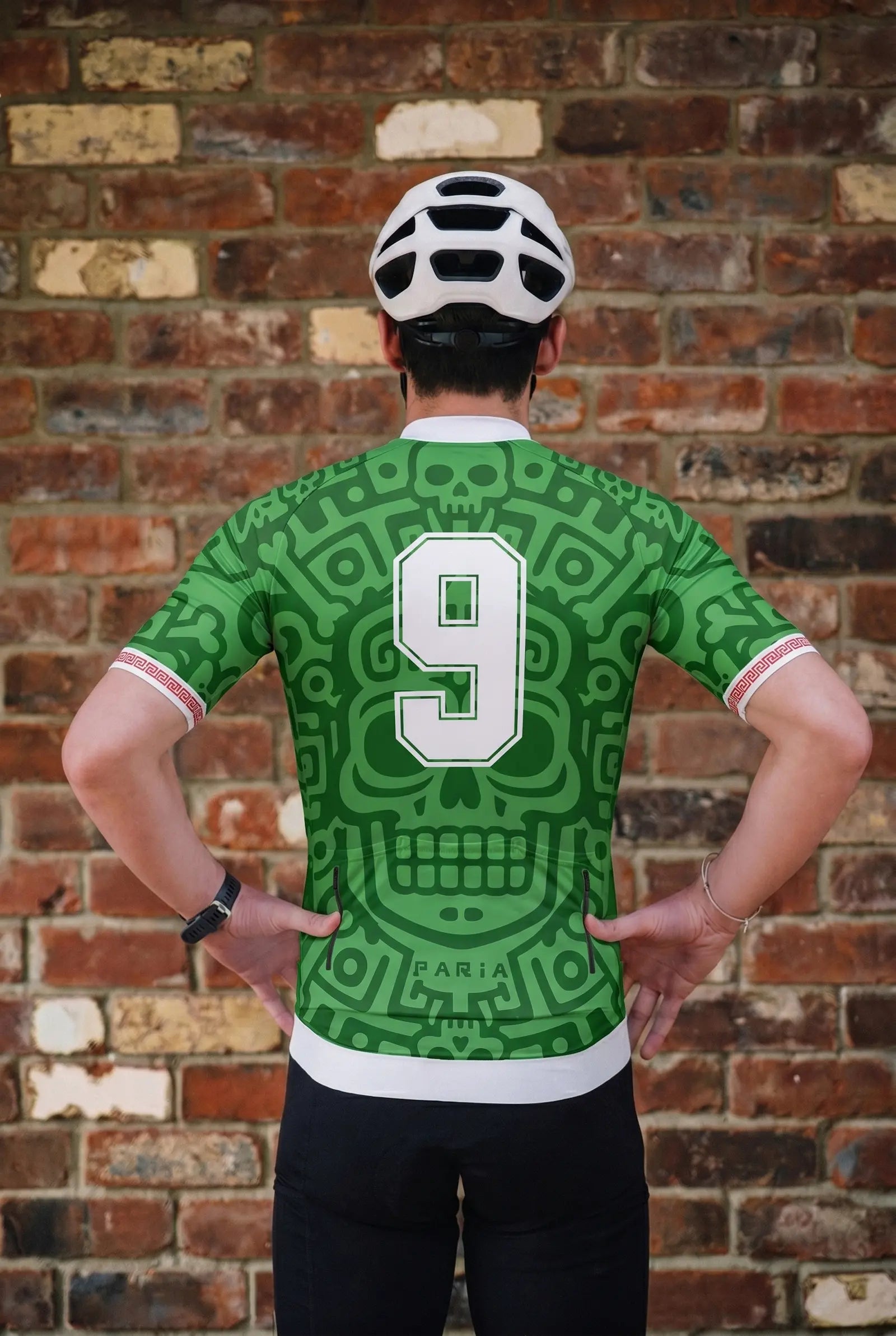 Person wearing a green sports jersey with number 9 and 'Parra' branding, standing against a brick wall.