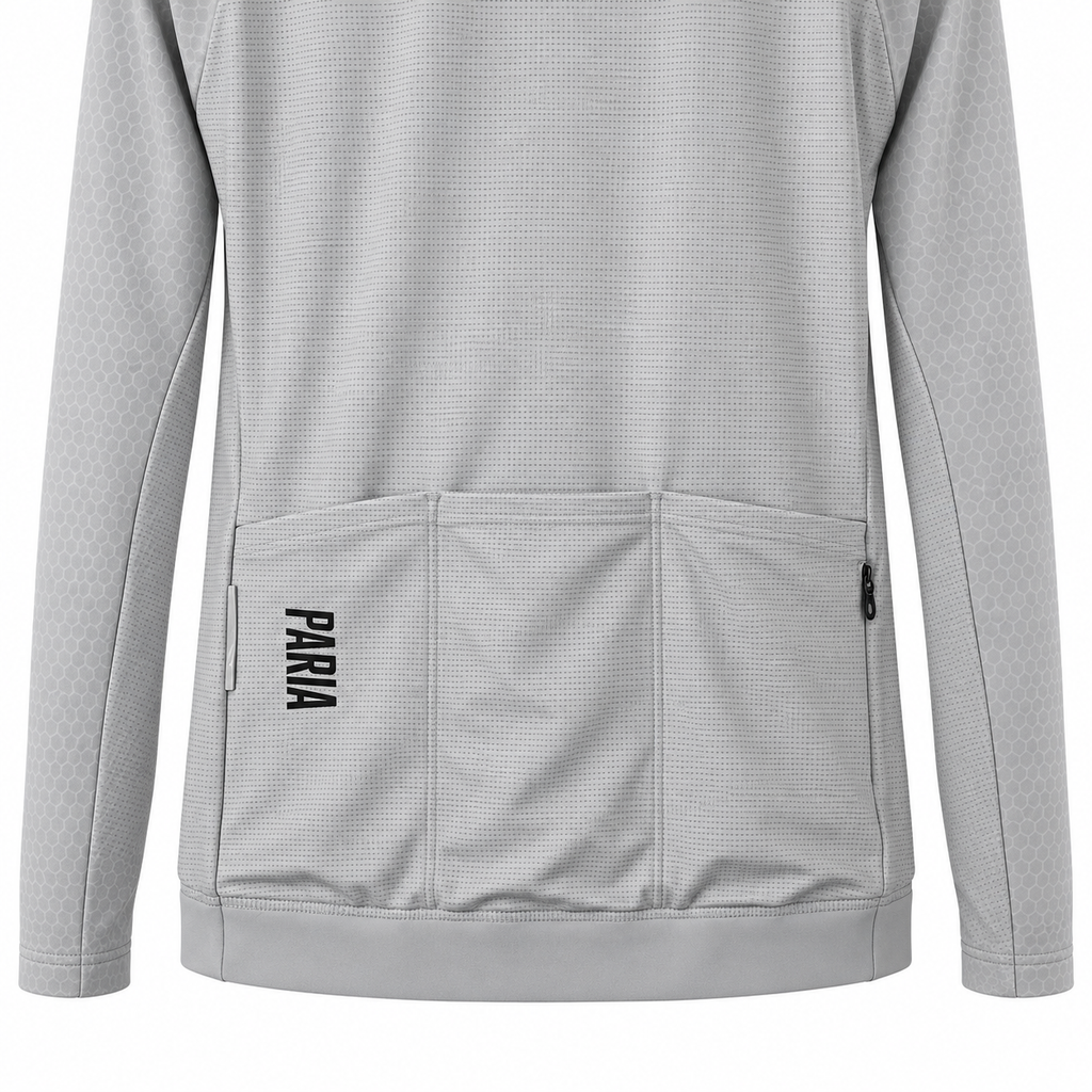 A light gray long-sleeve athletic jacket with a textured waffle fabric, featuring a large front utility pocket with the brand name 'PARIA' printed vertically in black on the lower left pocket.