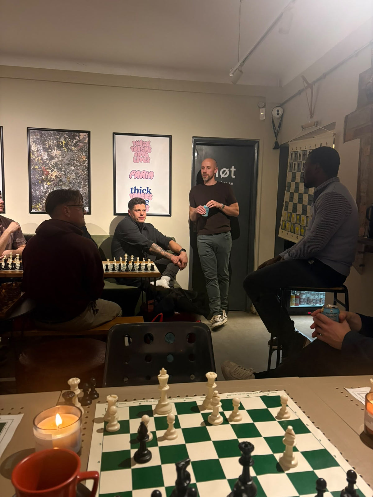 People sit and discuss chess together at the PARIA coffee shop