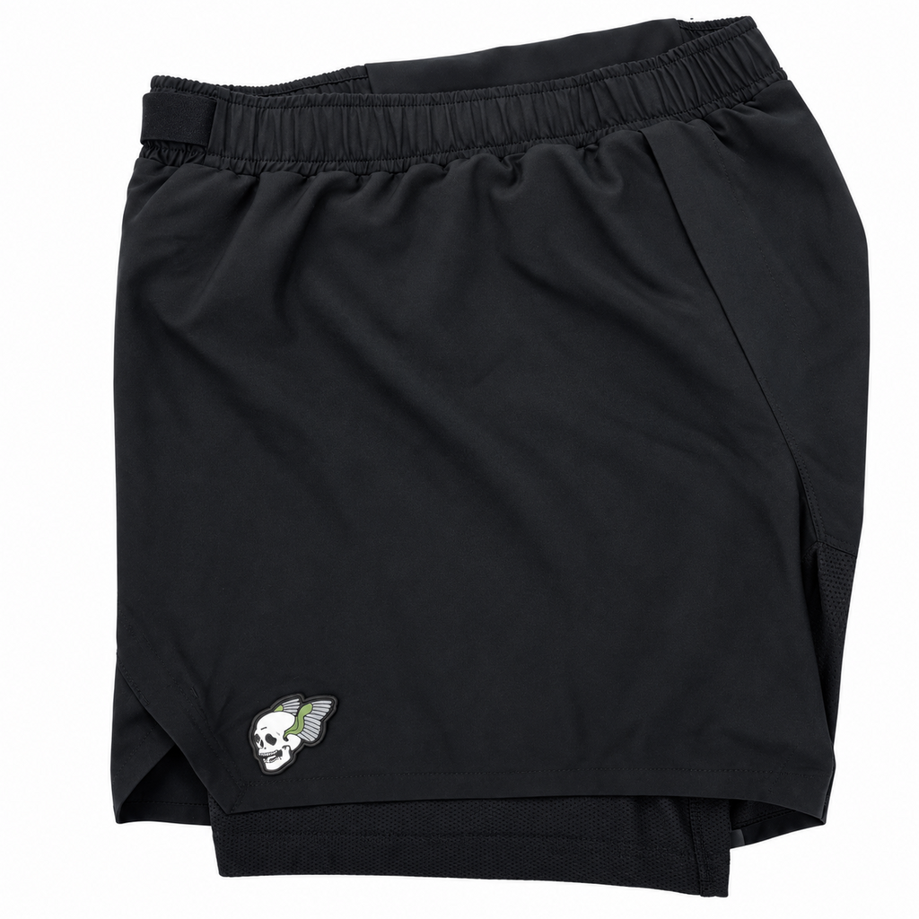 Black athletic shorts with an elastic waistband and a small embroidered mascot logo on the left leg, shown on a plain white background.