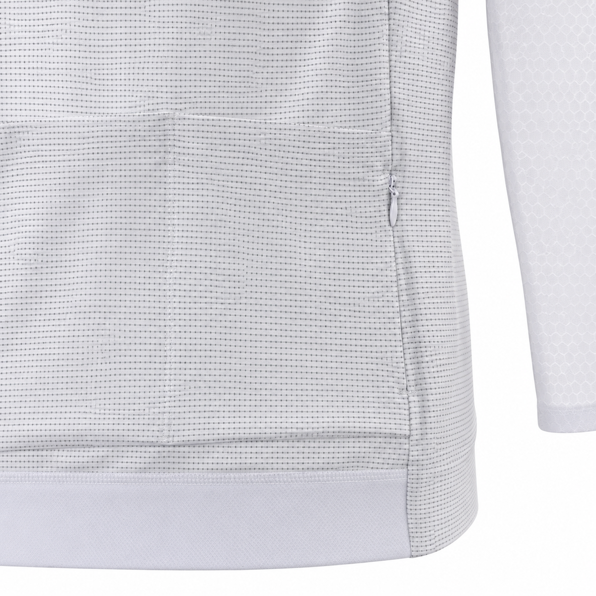 Close-up of a white long-sleeve athletic top showing the textured fabric, side seam, and zipper detail.