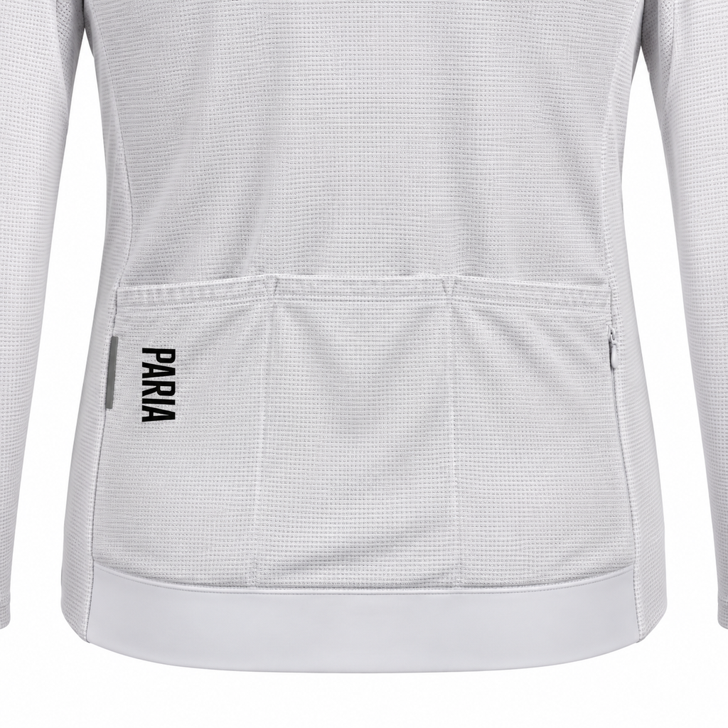 Close-up of the back of a white long-sleeve cycling jersey with a textured waffle knit fabric, a large rear pocket, and the brand name 'PARA' printed vertically in black on the pocket.