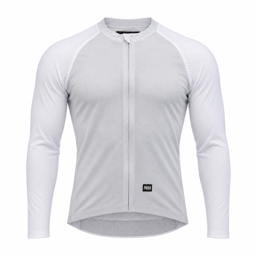 A white long-sleeve cycling jersey with a full-length front zipper, raglan sleeves, and a small black PUMA logo patch near the lower hem, shown on a clean white background.