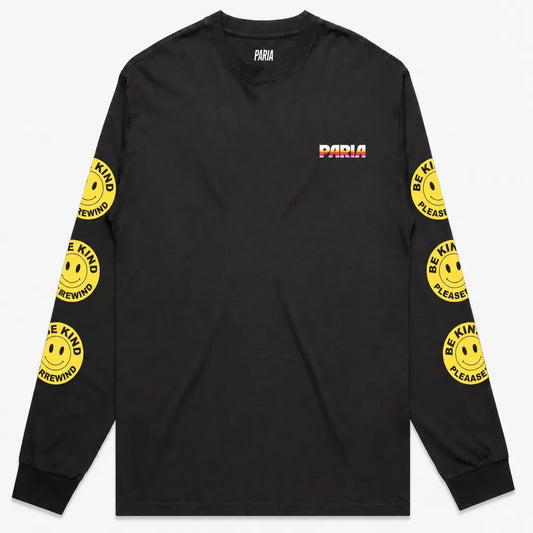 Black long-sleeve t-shirt with PARIA printed on the front left breast in a white, orange, and pink gradient. The sleeves feature yellow smiley face graphics with the text 'BE KIND REWIND'.