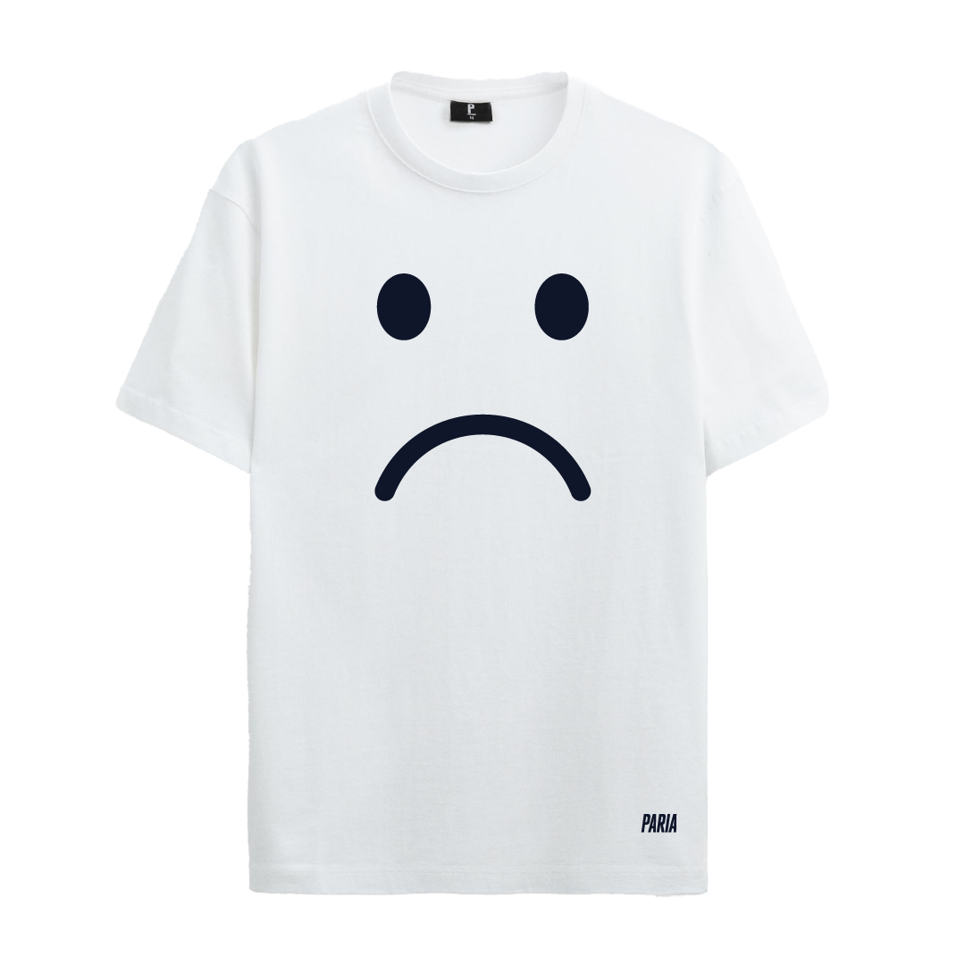 A white crew neck t-shirt with a large graphic print of a sad face in black.