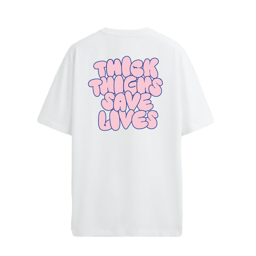 White crew neck t-shirt with the text 'THICK THIGHS SAVE LIVES' printed in bold pink font on the back.