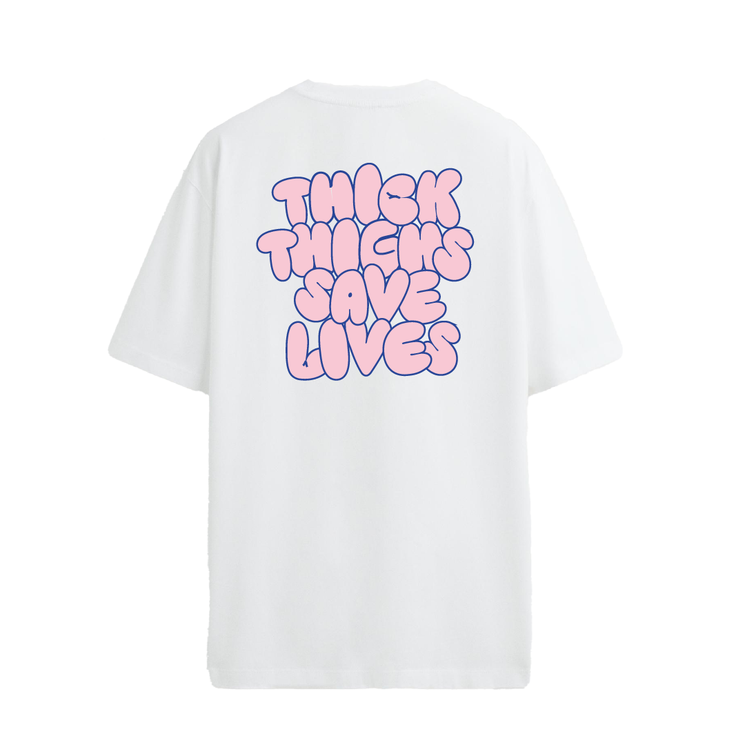 White crew neck t-shirt with the text 'THICK THIGHS SAVE LIVES' printed in bold pink font on the back.