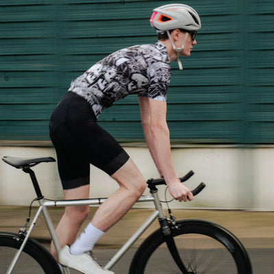 Person riding a bicycle on a road with a blurred background
